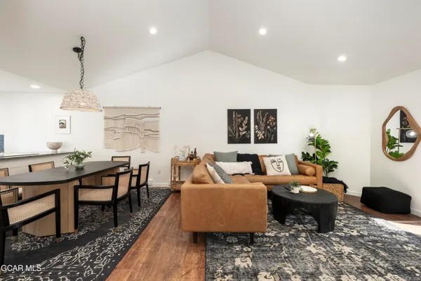 a living room with furniture a window and a table