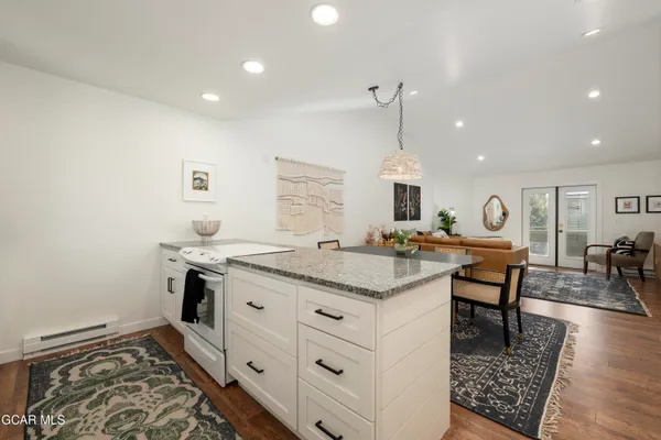 a kitchen with stainless steel appliances granite countertop a sink and a stove