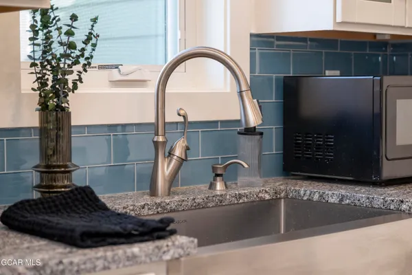 a kitchen with a sink and a stove