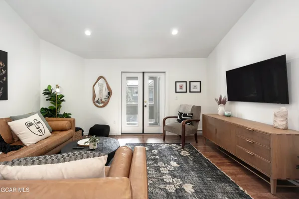 a living room with furniture and a flat screen tv