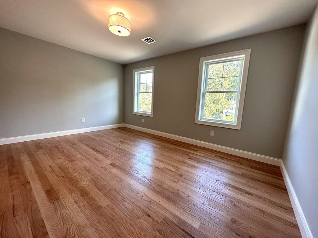 225 High Street Canton, MA 02021 - Photo 14 of 22 an empty room with wooden floor and windows