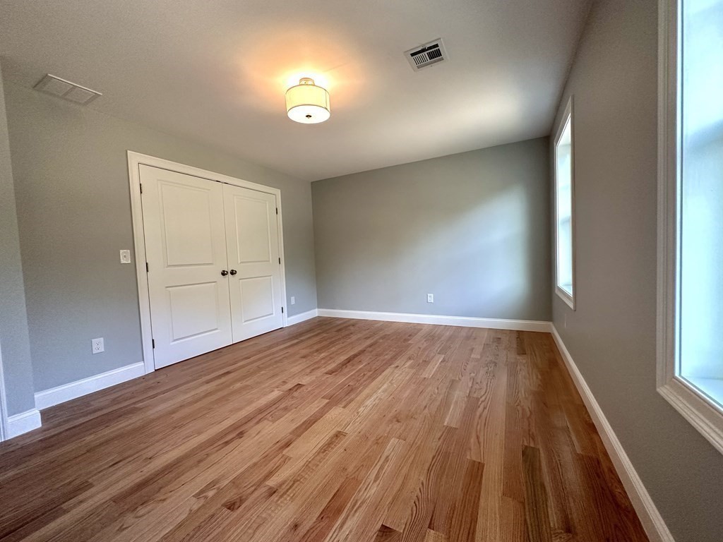 225 High Street Canton, MA 02021 - Photo 15 of 22 wooden floor in an empty room with a window