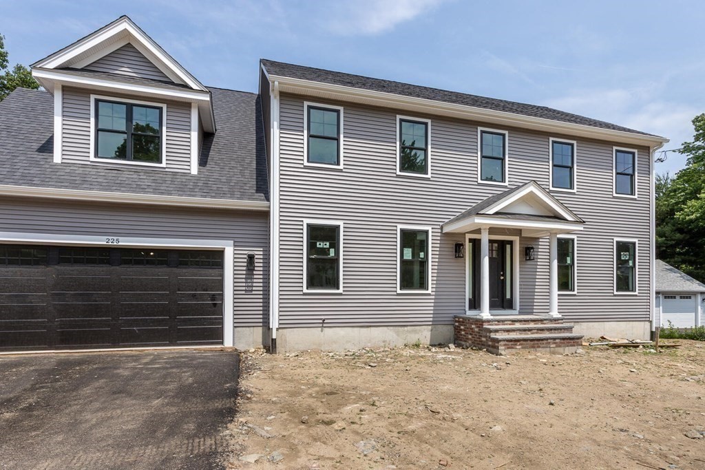 225 High Street Canton, MA 02021 - Photo 22 of 22 a front view of a house with a yard and garage