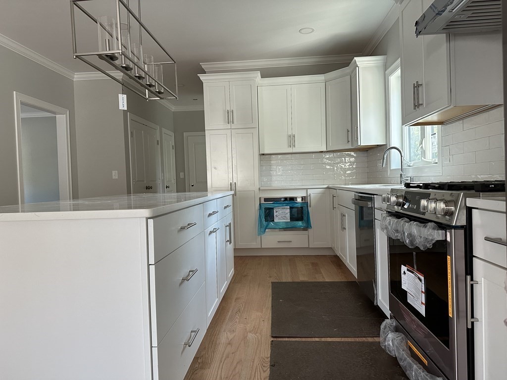 225 High Street Canton, MA 02021 - Photo 5 of 22 a kitchen with a sink stove and cabinets