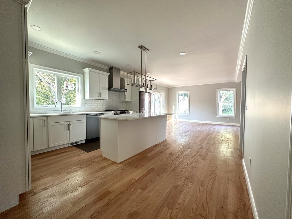 225 High Street Canton, MA 02021 - Photo 6 of 22 a large kitchen with cabinets wooden floor and stainless steel appliances