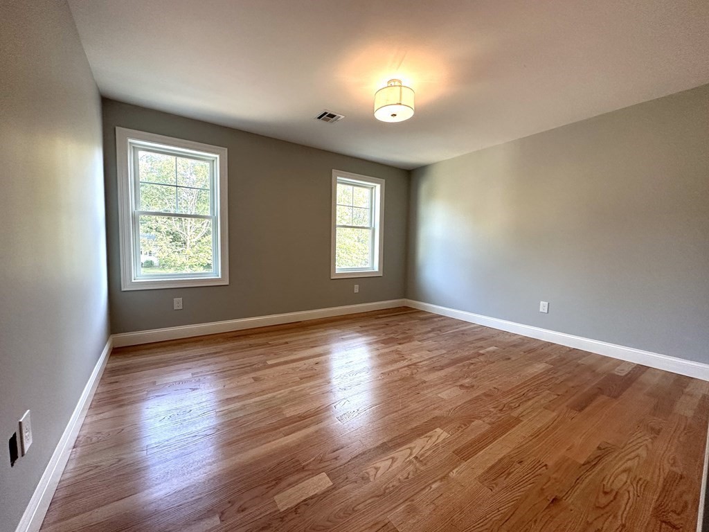 225 High Street Canton, MA 02021 - Photo 10 of 22 a view of an empty room with window and wooden floor