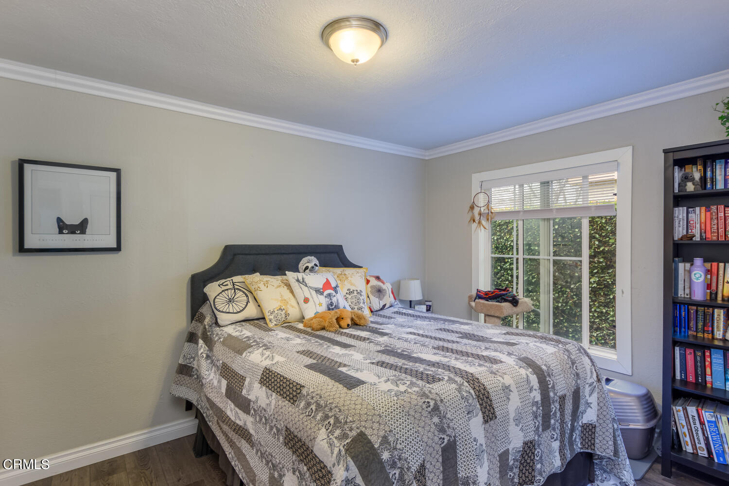 612 West Roderick Avenue Oxnard, CA 93030 - Photo 16 of 26 a bedroom with a bed and a book shelf
