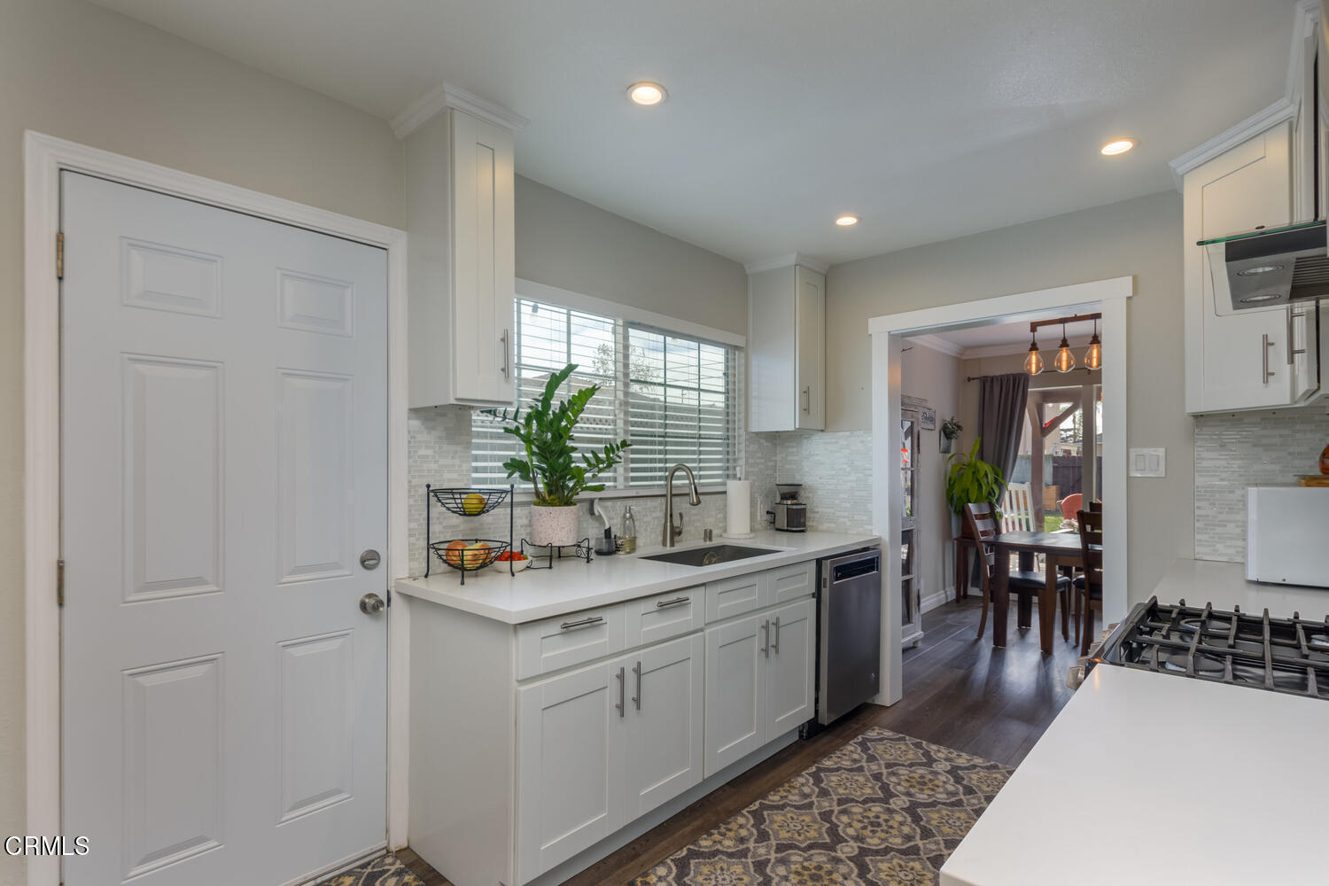 612 West Roderick Avenue Oxnard, CA 93030 - Photo 8 of 26 a hallway with white cabinets and wooden floor