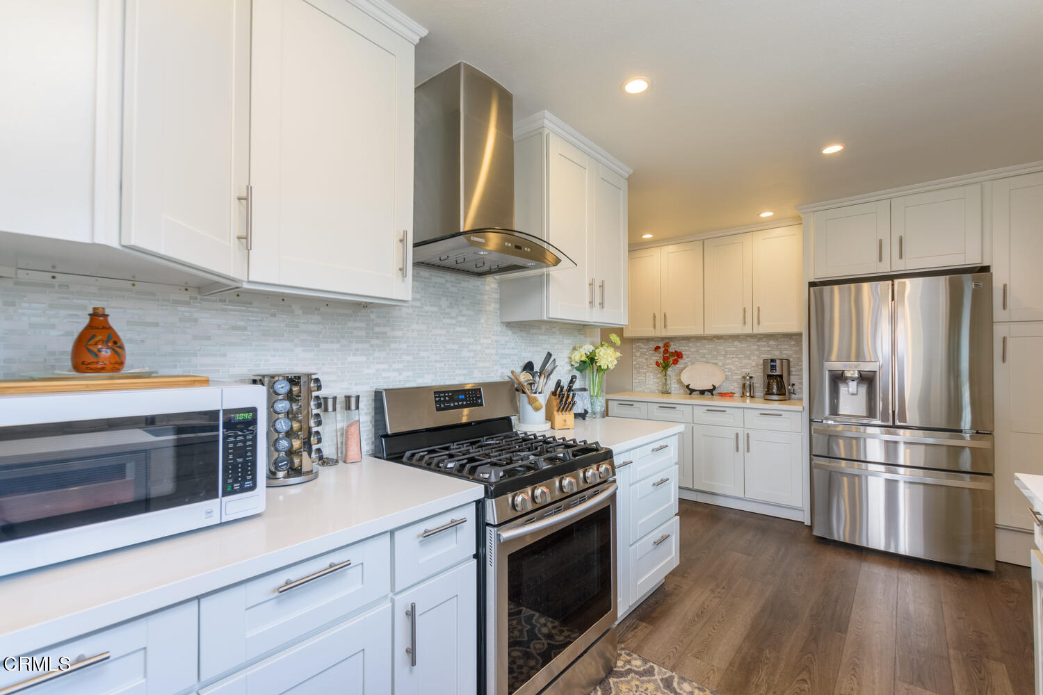 612 West Roderick Avenue Oxnard, CA 93030 - Photo 9 of 26 a kitchen with cabinets stainless steel appliances and wooden floor