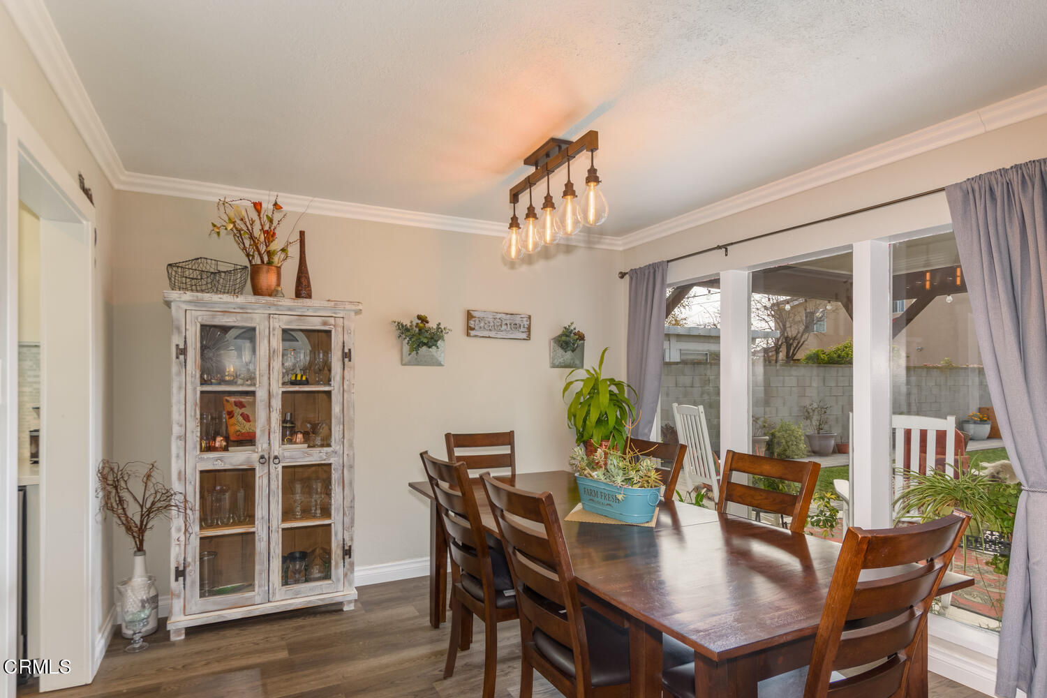 612 West Roderick Avenue Oxnard, CA 93030 - Photo 10 of 26 a view of a dining room with furniture window and wooden floor