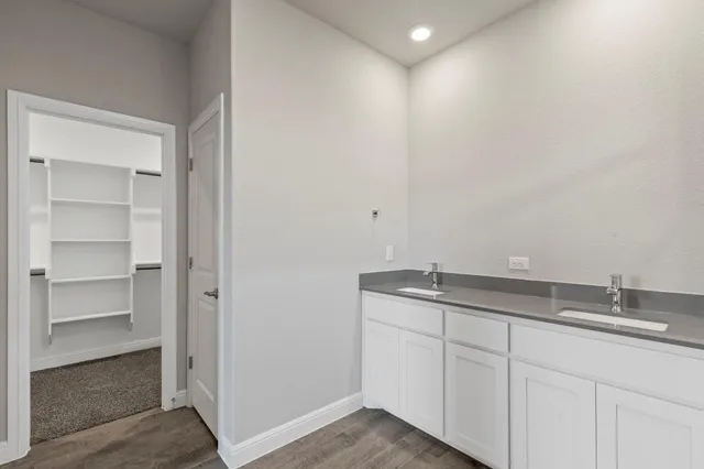 a bathroom with a granite countertop sink mirror and vanity