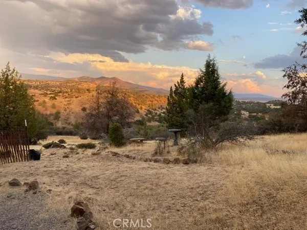 a view of a house with a wooden deck