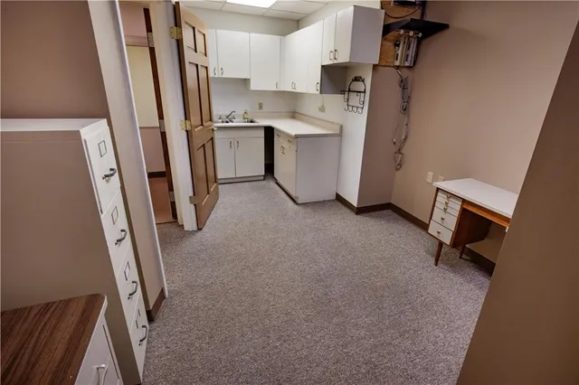 a room with water heater and white walls