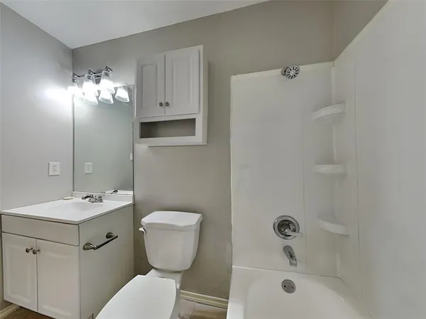 a bathroom with a sink toilet a shower and a mirror