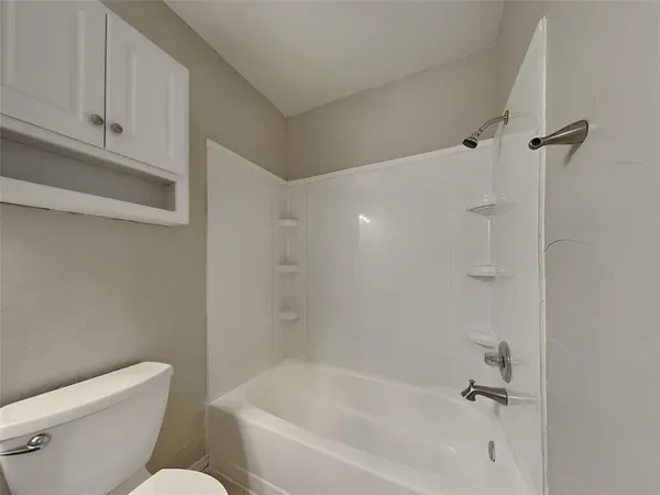 a white bath tub sitting next to a white toilet