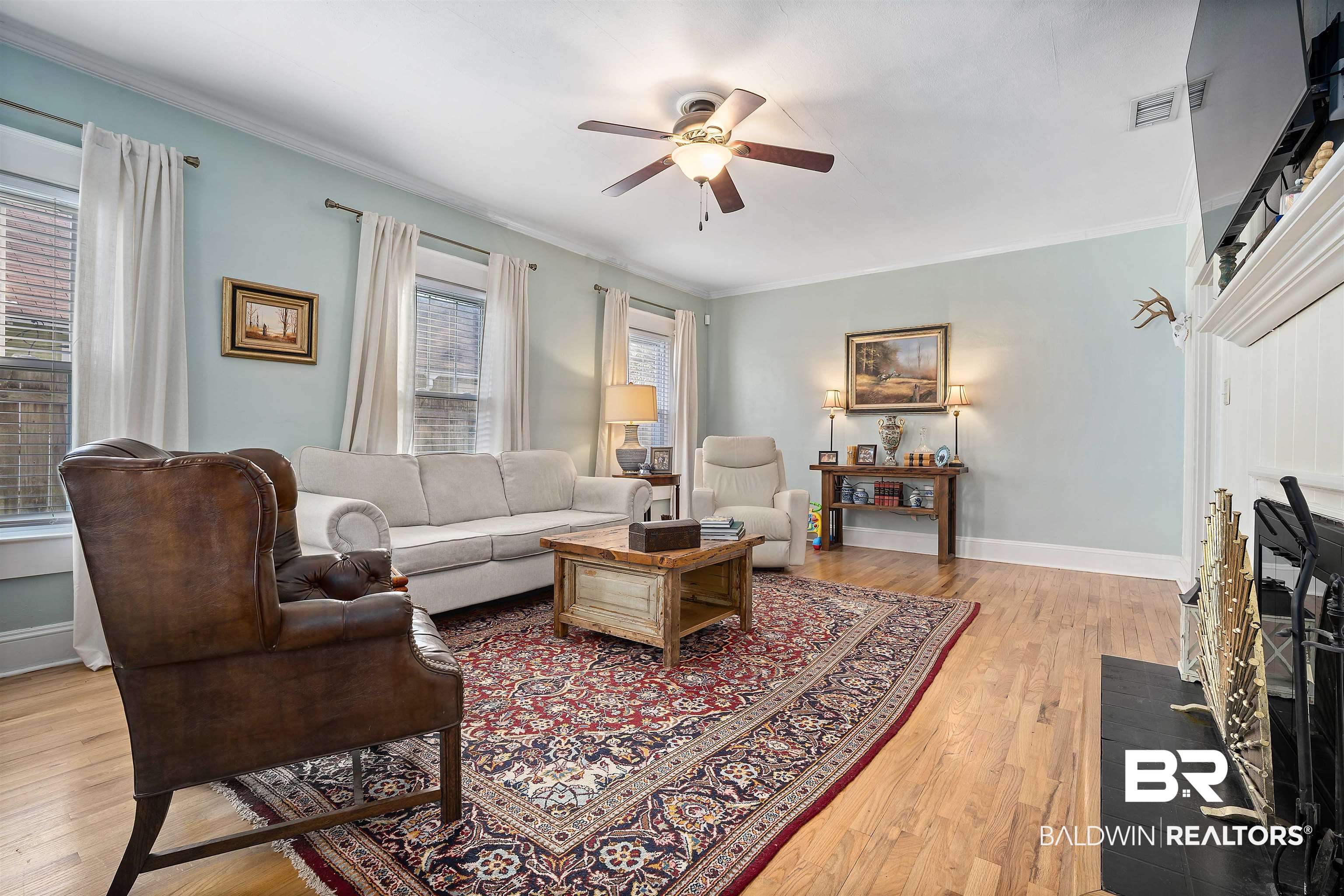 168 Mohawk Street Mobile, AL 36606 - Photo 7 of 31 Living area featuring a fireplace with flush hearth, light wood-style flooring, ceiling fan, and ornamental molding