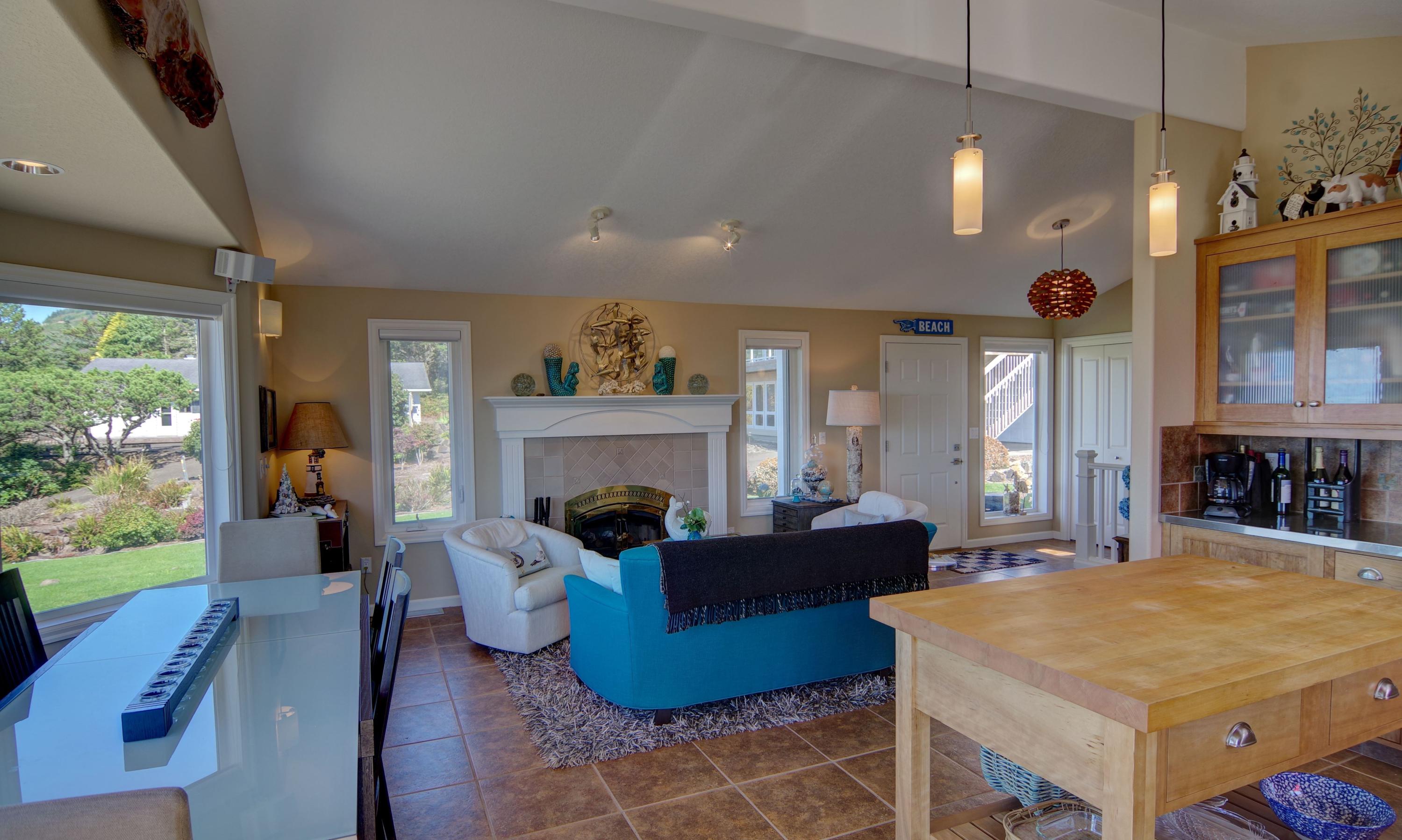 1065 Arthurs Road Oceanside, OR 97141 - Photo 13 of 47 a living room with furniture a large window and a fireplace