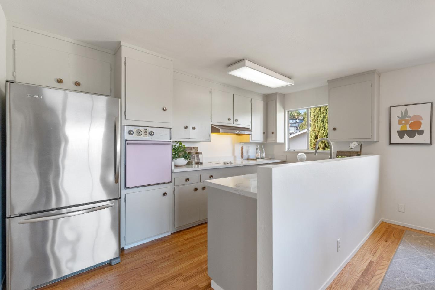 2203 Ewell Road Belmont, CA 94002 - Photo 9 of 50 a kitchen with stainless steel appliances a refrigerator a sink a stove a microwave and cabinets