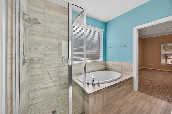 a bathroom with a tub and shower