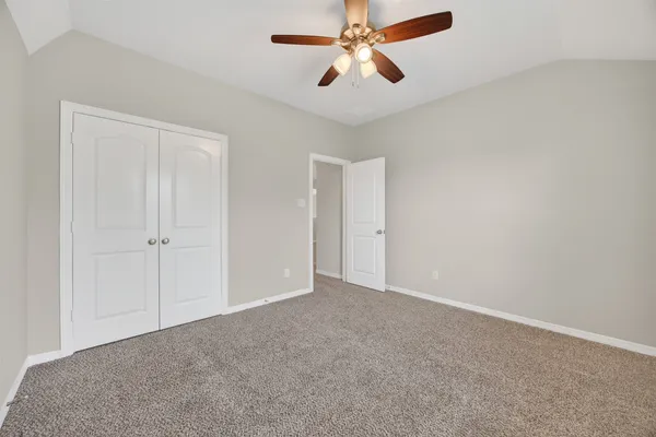 a view of a livingroom with a ceiling fan and window