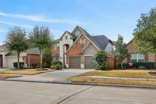 a front view of a house with a yard and a garage