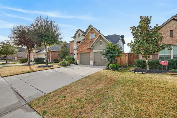 a view of a hallway to a bedroom with wooden floor and entryway