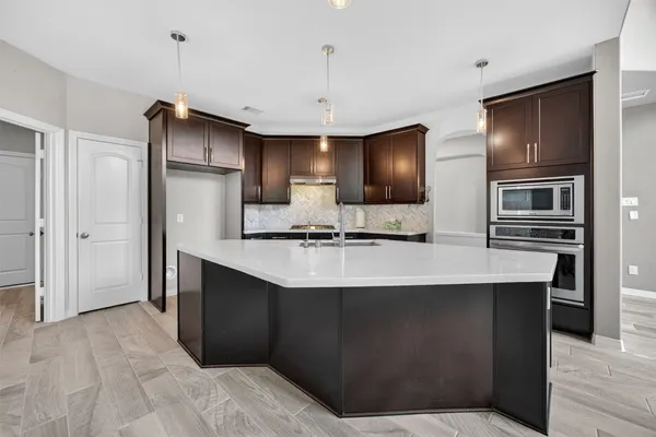 a kitchen with stainless steel appliances a sink and refrigerator