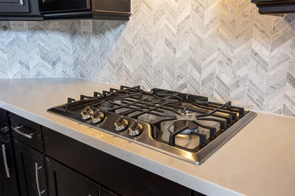 a close up of a stove sitting inside of a kitchen