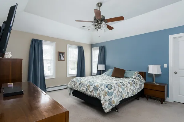 a bedroom with a bed and a chandelier