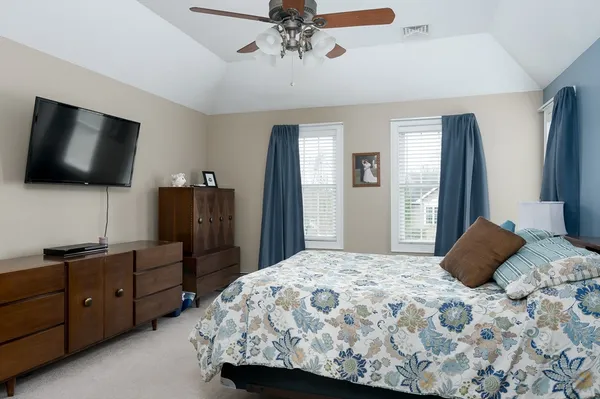 a bedroom with a bed and a flat screen tv