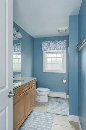 a bathroom with a toilet sink and window