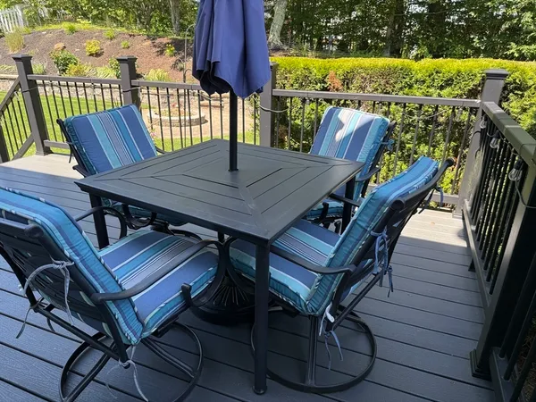 a view of a balcony with table and chairs