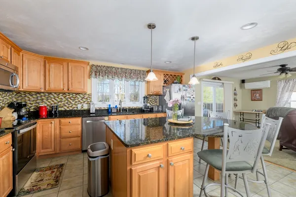 a kitchen with stainless steel appliances granite countertop a sink and cabinets