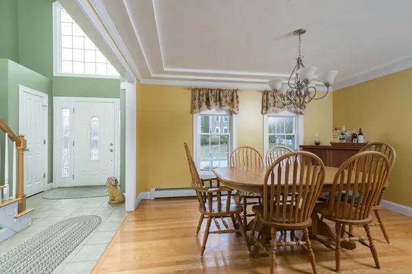 a view of a dining room with furniture wooden floor and chandelier