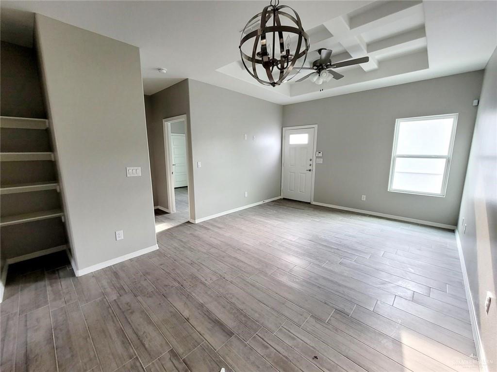 2109 Davenport Street, Unit 1 Weslaco, TX 78596 - Photo 4 of 13 wooden floor in an empty room with a window