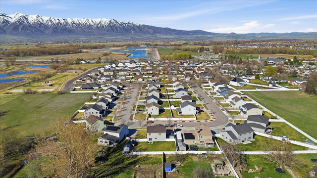 1084 South 740 East Logan, UT 84321 - Photo 19 of 23 Aerial view of property and surrounding area with nearby suburban area and a water and mountain view