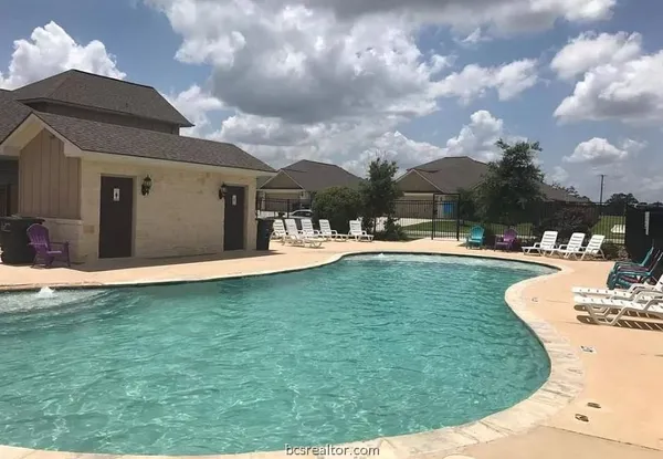a view of a swimming pool with a table and chairs
