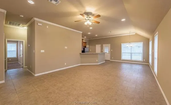 a view of a livingroom with a ceiling fan and window