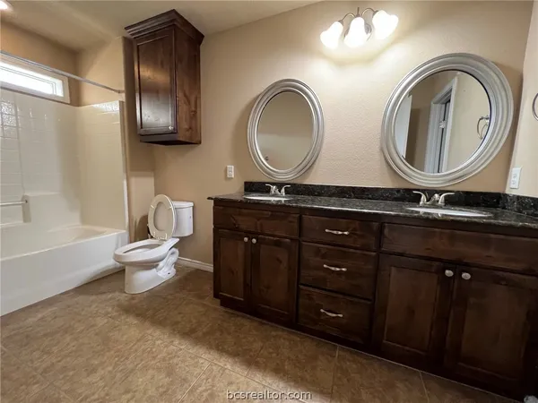a bathroom with a toilet a sink and a mirror