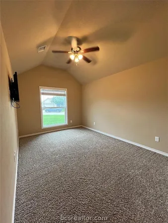 a view of a livingroom with a ceiling fan and window