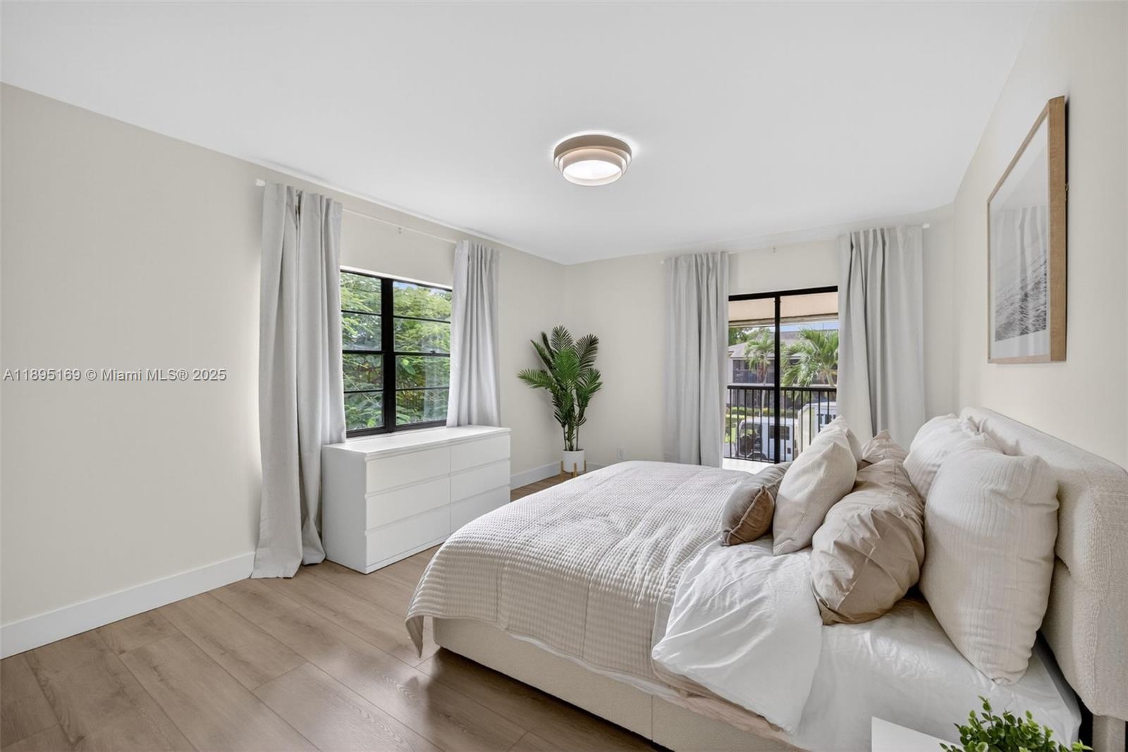 261 Deer Creek Boulevard, Unit 1205 Deerfield Beach, FL 33442 - Photo 12 of 38 a bedroom with a bed and window