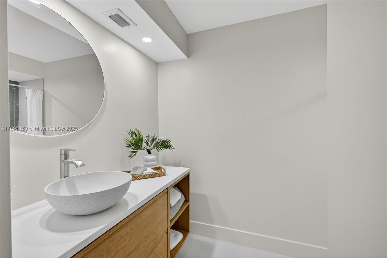 261 Deer Creek Boulevard, Unit 1205 Deerfield Beach, FL 33442 - Photo 17 of 38 a bathroom with a sink and a mirror