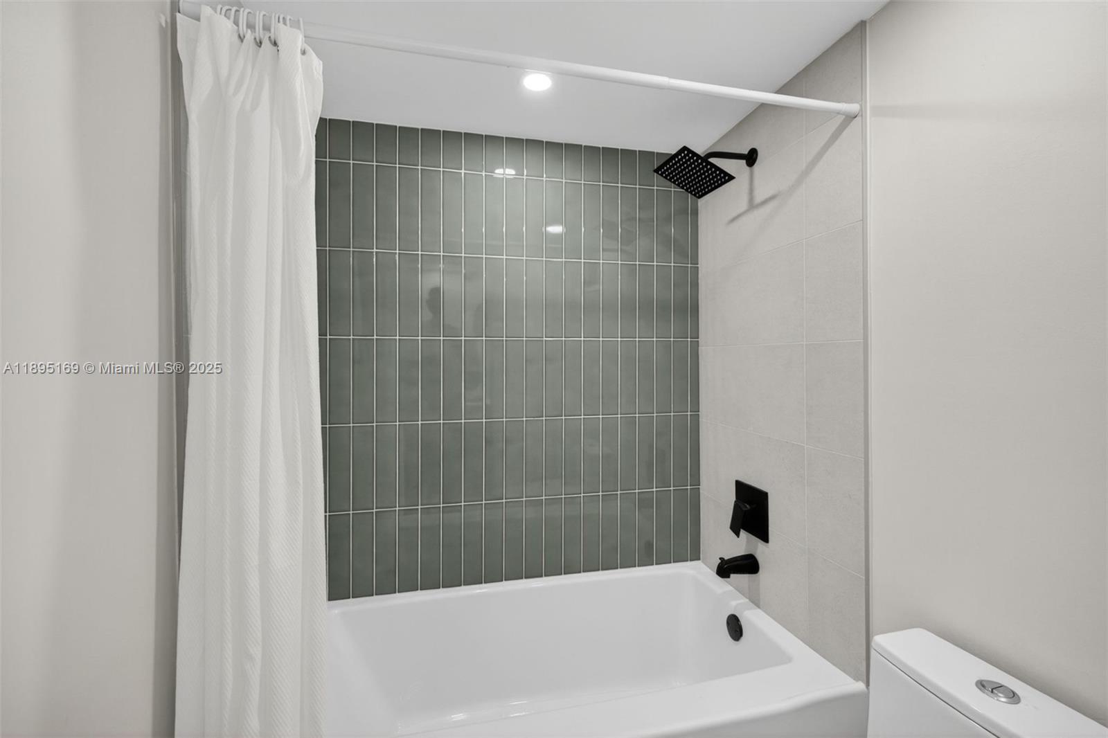 261 Deer Creek Boulevard, Unit 1205 Deerfield Beach, FL 33442 - Photo 19 of 38 a bathroom with a bathtub and a shower