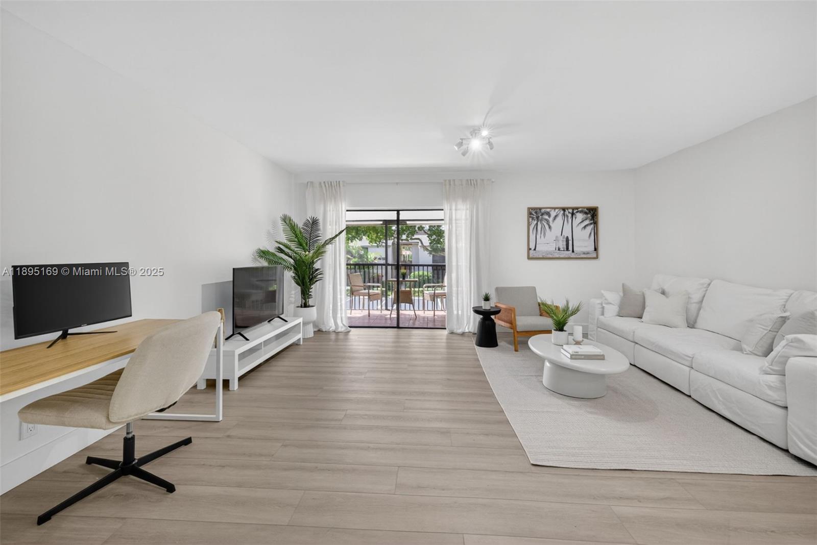 261 Deer Creek Boulevard, Unit 1205 Deerfield Beach, FL 33442 - Photo 2 of 38 a living room with furniture and a flat screen tv