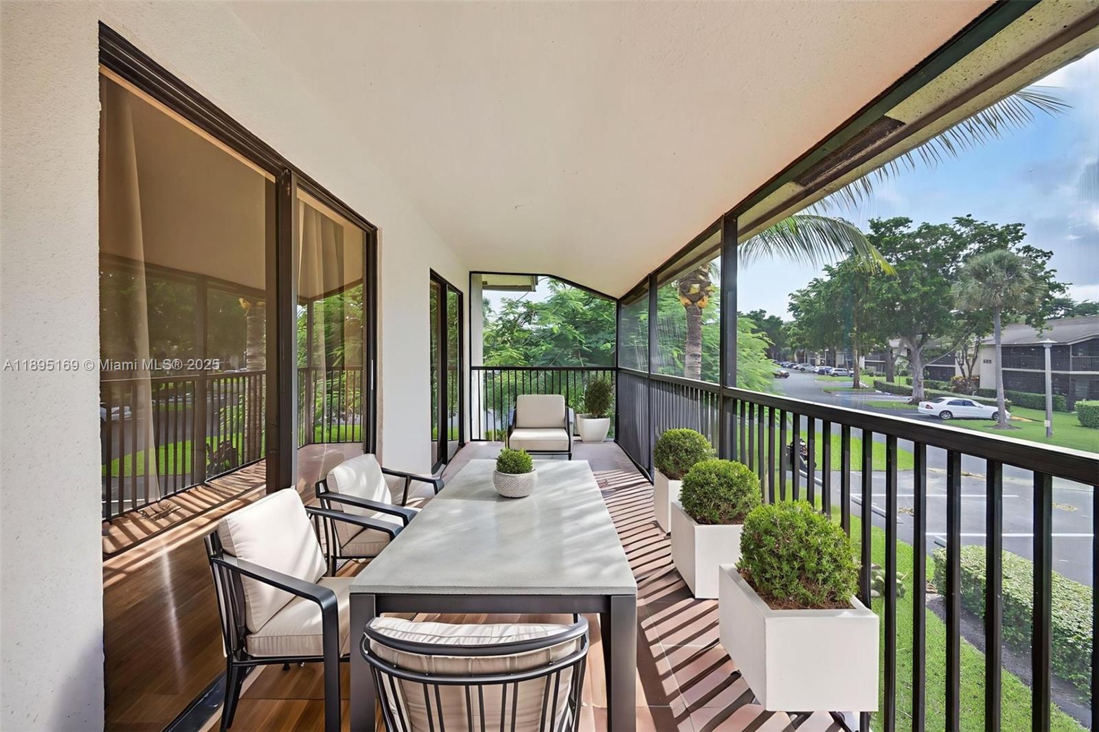 261 Deer Creek Boulevard, Unit 1205 Deerfield Beach, FL 33442 - Photo 22 of 38 a view of balcony with a table and chairs