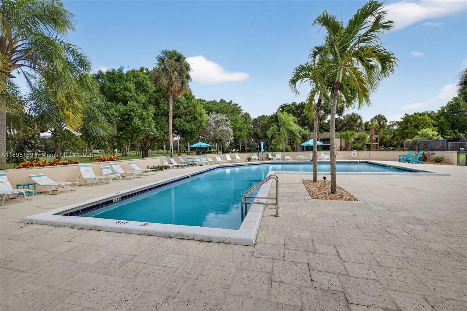 261 Deer Creek Boulevard, Unit 1205 Deerfield Beach, FL 33442 - Photo 25 of 38 a view of outdoor space with swimming pool and trees
