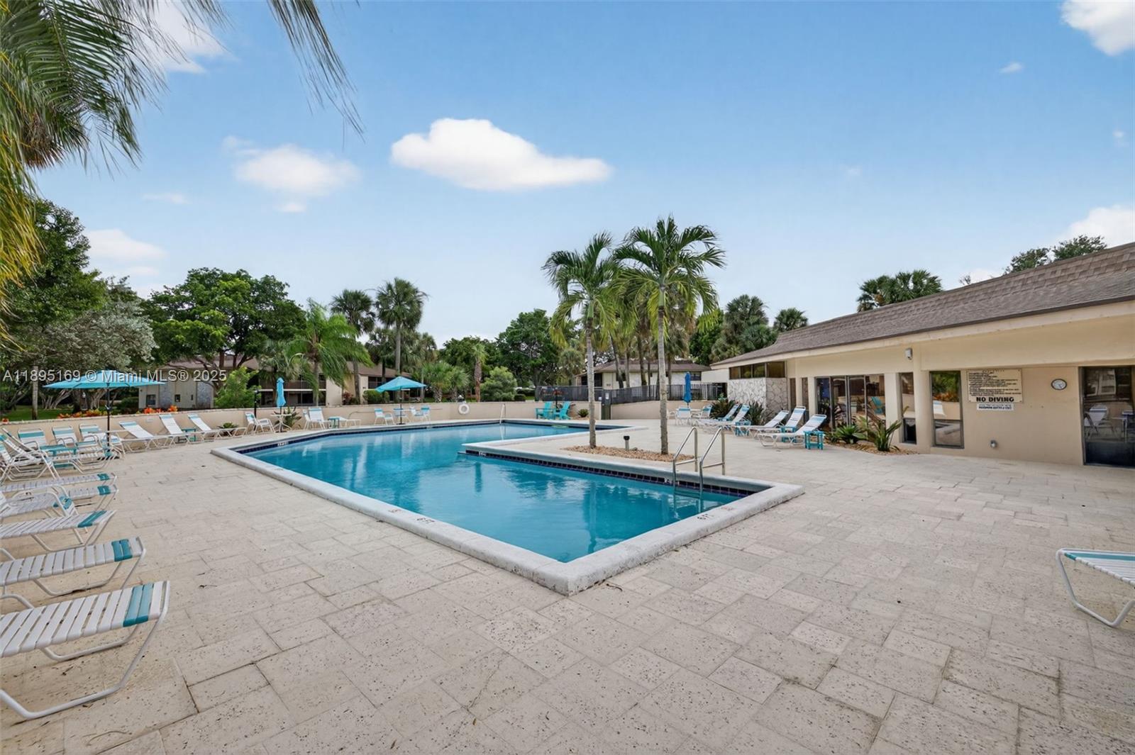 261 Deer Creek Boulevard, Unit 1205 Deerfield Beach, FL 33442 - Photo 26 of 38 a view of outdoor space and swimming pool