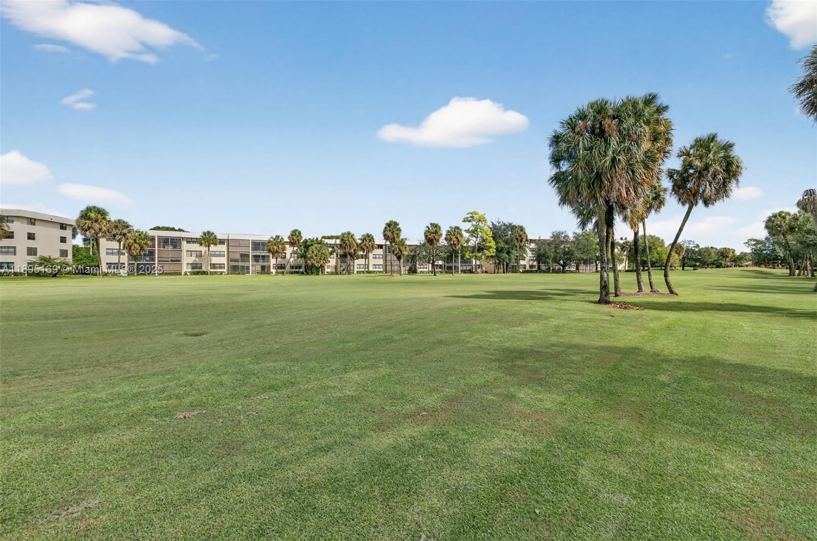 261 Deer Creek Boulevard, Unit 1205 Deerfield Beach, FL 33442 - Photo 28 of 38 a view of a park with large trees