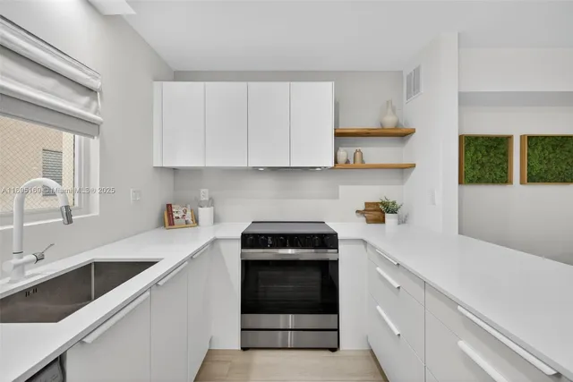 a kitchen with a sink stove and cabinets
