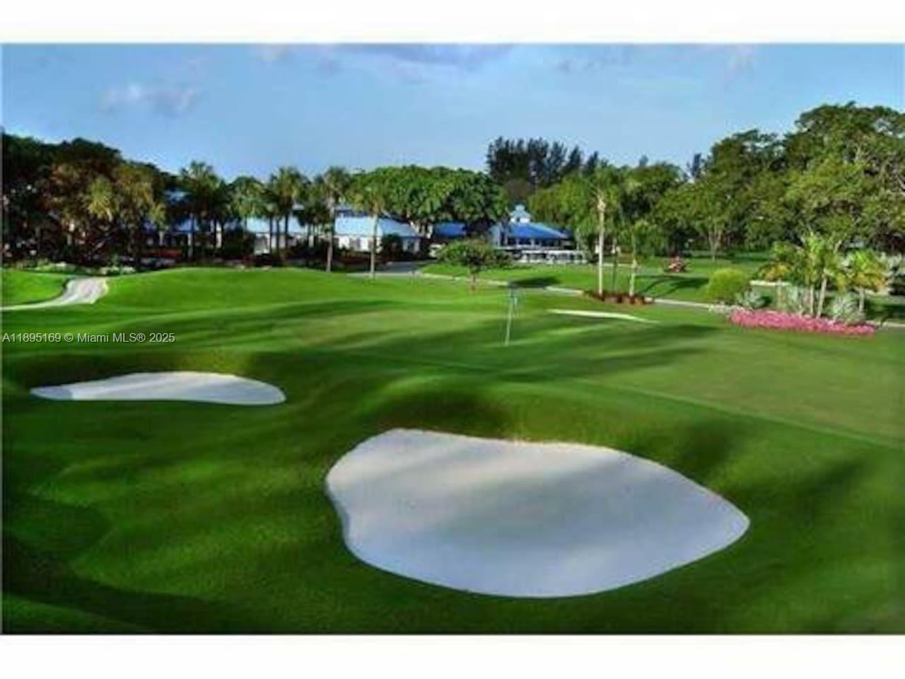 261 Deer Creek Boulevard, Unit 1205 Deerfield Beach, FL 33442 - Photo 33 of 38 a view of a golf course with a garden